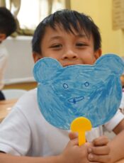 Student showing his picture at drawing class